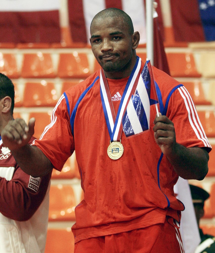 Cuban Yoel Romero celebrates after receiving the gold medal for the wrestling 84 Kg category, 08 August 2003 at the XIV Pan American Games in Santo Domingo, Dominican Republic.          AFP PHOTO/Omar TORRES (Photo by OMAR TORRES / AFP)